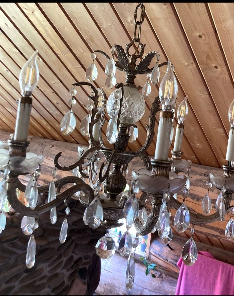 Chandelier with crystal drops, showcasing elegance, featured in a cleaning services context.