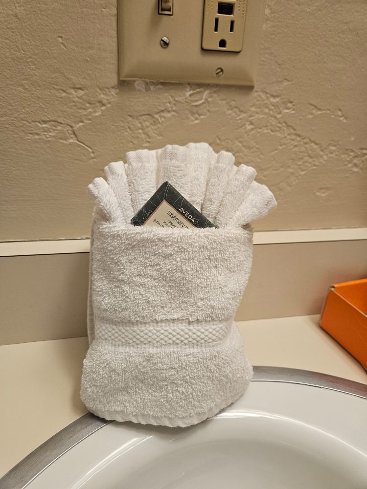 A towel bag placed on a sink, indicating a cleaning services setup.