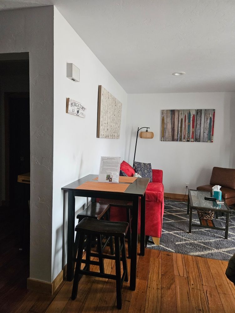 Living room featuring a table and chairs, highlighting a clean and organized space for cleaning services.